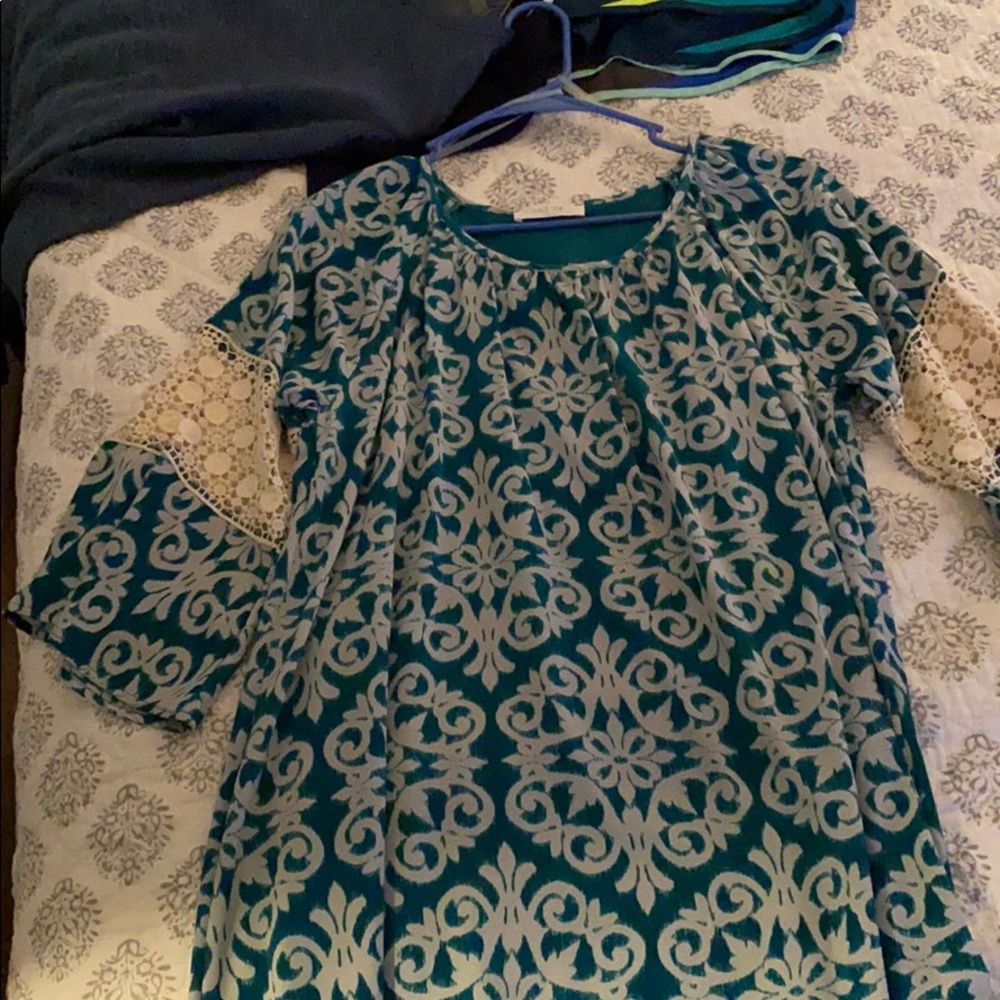 Dress: green with white swirls.